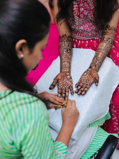 Here I am, in my element, applying the final touches to a bride's henna. I believe in giving my full focus and care to every client, ensuring the experience is as beautiful as the design itself.