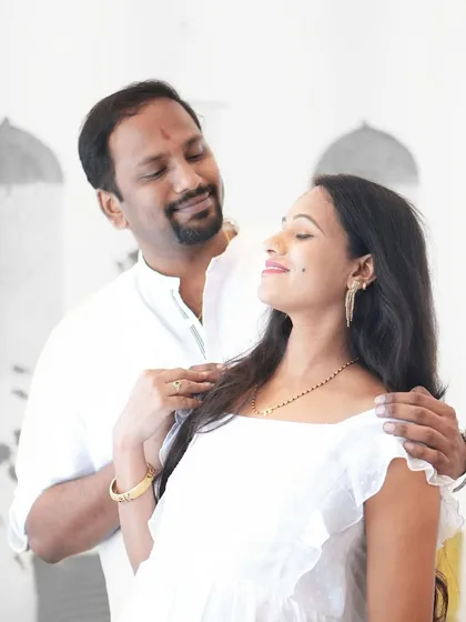 An intimate portrait of a couple during their maternity session. The soft, natural light and their gentle interaction create a feeling of warmth and love.