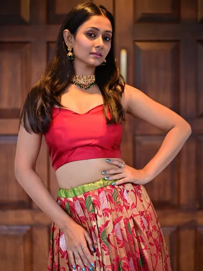 A strong pose that shows off the complete look. The makeup is balanced, with enough definition to stand out without distracting from the model herself.