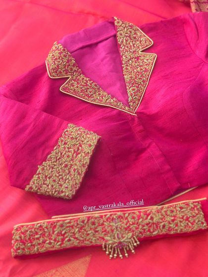 A modern pink blouse with a tuxedo-style collar, fully embroidered.