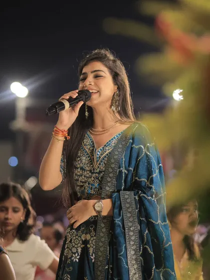 A smile on my face as I sing, surrounded by the happy faces of the guests. This is what I live for, spreading joy through my music.