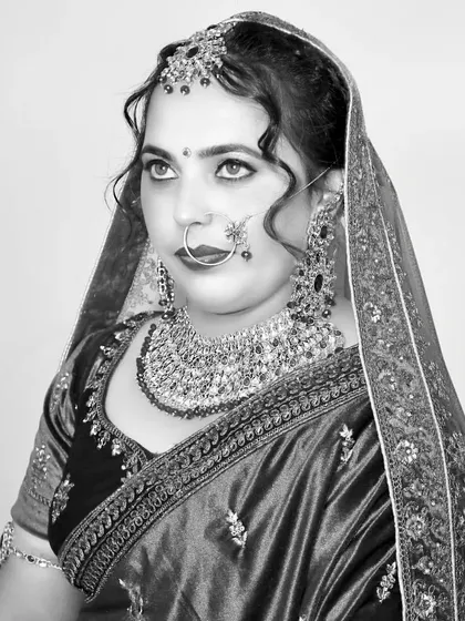 A classic black and white bridal portrait, her gaze looking away, creating a thoughtful and elegant mood.