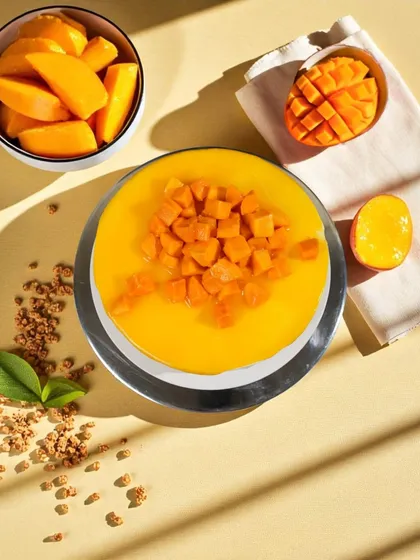 A slice of sunshine in every bite. This top-down view shows the vibrant, natural color of our Mango Cake, bursting with real mango magic.