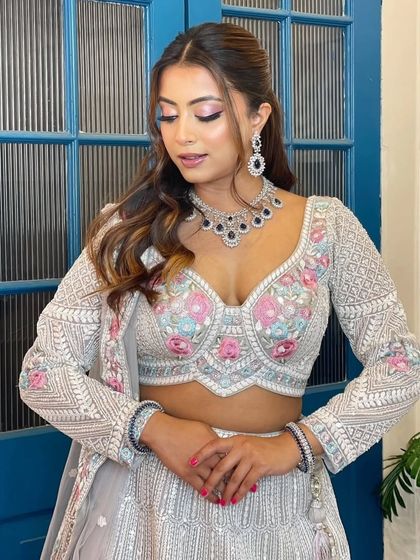A modern, fashion-forward look featuring a pearl-encrusted gown. The simple diamond drop earrings are the perfect accessory for this statement outfit.