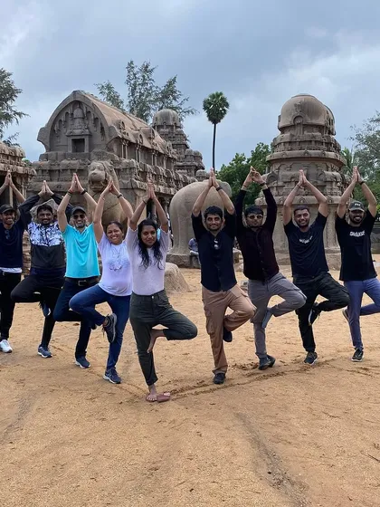 Our practice travels with us. Here, our community finds balance with a group Tree Pose (Vrikshasana) amidst the ancient stone temples of Mahabalipuram. It’s a beautiful reminder that yoga can be a source of connection and joy, wherever you are.