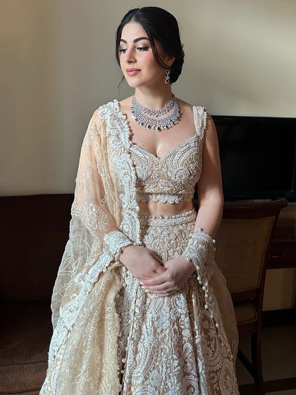 Soft, angelic, and radiant for Oezlem's sangeet. This look features a dewy base, soft pink tones on the eyes and lips, and a romantic updo, creating a dreamy and ethereal appearance.