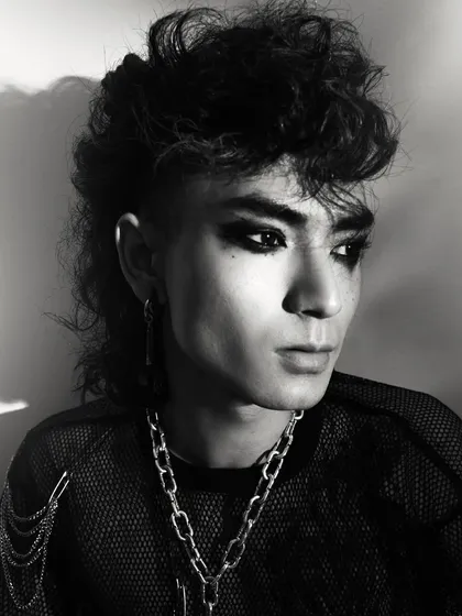 A black and white portrait from a men's fashion editorial with a punk-rock theme. I used high-contrast lighting to carve out the model's features and emphasize the texture of his hair and the attitude of the styling.