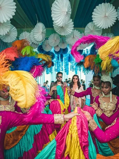 A close-up of the carnival performers with their colorful feathered headgear. These details are what make the entry a truly immersive experience.