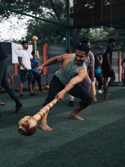 A member demonstrates a dynamic lunge with a Gada, showcasing the focus and power required. This is a perfect example of how we combine traditional tools with functional movements to build strength that is useful in everyday life.