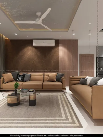 A sophisticated living room with a dual sofa arrangement. The design uses a mix of leather upholstery, textured walls, and a patterned ceiling to create a layered and luxurious feel.