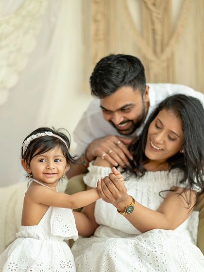 A happy family in white, sharing a dance and a smile. The light and airy feel of this photo is just beautiful.