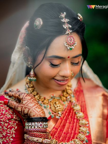 A close-up portrait showing the intricate details of her henna and jewellery, with her makeup looking soft and pretty.