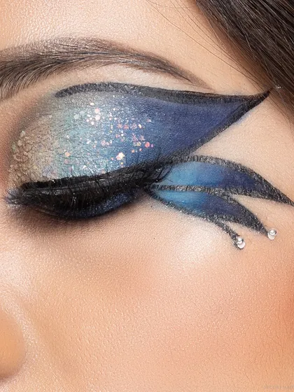 An example of creative beauty photography, highlighting elaborate, artistic eye makeup. This type of glamour portrait is ideal for makeup artists' portfolios or bold personal statements.