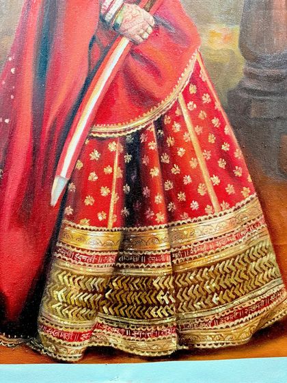 A close-up on the intricate gold and red patterns of the lehenga from the royal portrait. I love getting lost in these details.