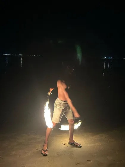 Here’s a shot of me spinning fire poi by the ocean. Learning with practice poi is the first step, but this is where the real magic happens. It’s an incredible feeling of focus and energy.