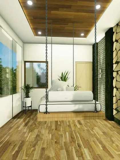 A balcony design featuring a large swing, a stone accent wall, and floor-to-ceiling glass windows that connect it to the indoors.