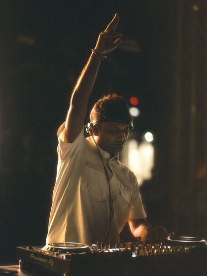 A focused shot of me at the decks during the IIM Bangalore campus tour show.
