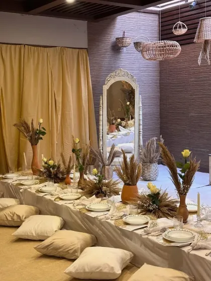 Another view of the intimate dinner setup, showing a vintage-style mirror and hanging wicker lanterns. These details helped create a layered and visually interesting space.