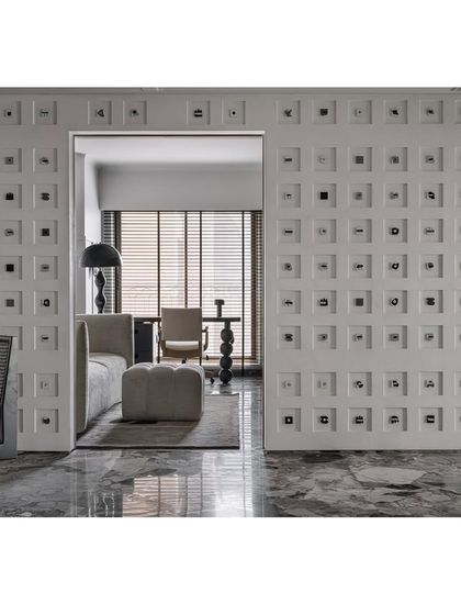 The 'Decode 260' Morse code wall acts as a showstopping room divider, creating an alluring entrance to the living space.