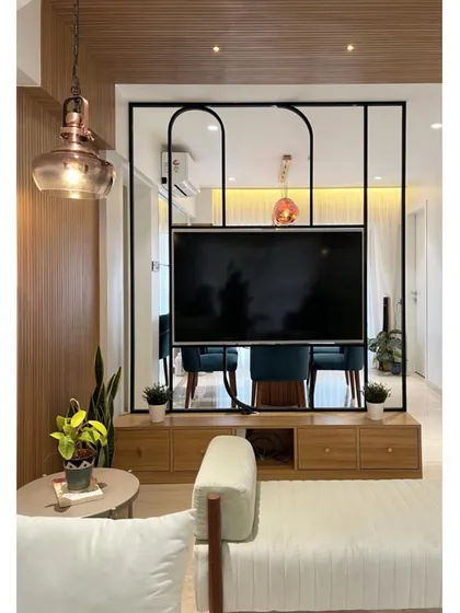 Another view of the rotating TV partition, showcasing its minimal frame and how it maintains visual connectivity between the two rooms.