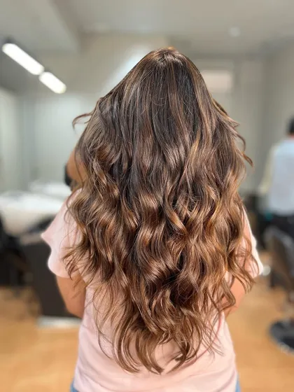 This warm brown balayage was paired with an Olaplex treatment to ensure the hair stayed strong and healthy throughout the coloring process.