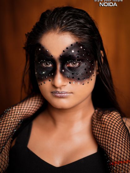A dark and glamorous fantasy look with a black, studded mask effect. This shows how to blend edgy and beautiful elements.