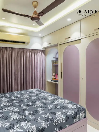 This view shows the custom wardrobe with arched details, matching the room's overall design theme.