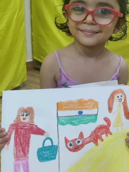 This student's drawing tells a story with a person, a cat, and the Indian flag. The free-form characters and bold colours are a wonderful example of expressive childhood art.