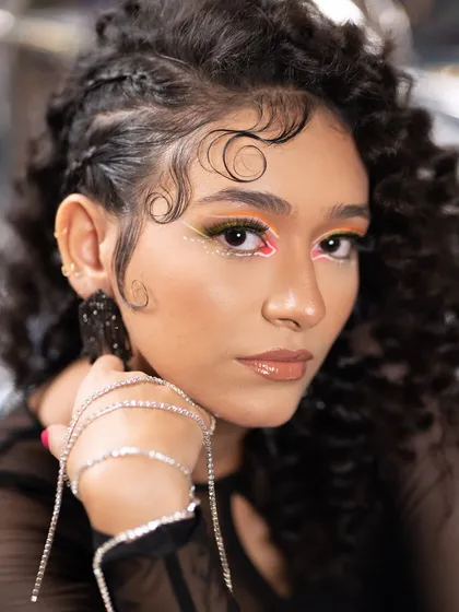 I love playing with color and texture. This look features edgy, multi-colored nails that match the creative graphic makeup. It’s a perfect example of how I can create a custom nail set to match your unique vibe and style.