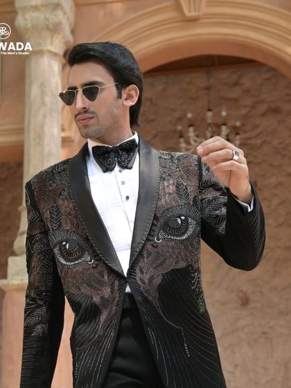 A dynamic angle of the eye-motif tuxedo, highlighting the texture and shimmer of the beadwork. This is a perfect outfit for a cocktail night or a fashion-forward reception.