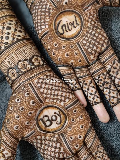 A close-up of the 'Boy' or 'Girl' mehndi, a popular and exciting design for baby showers and gender reveal parties.