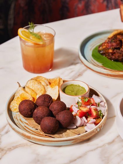 Mid-week cravings sorted. A plate of our signature fried bites with a zesty green chutney and a refreshing cocktail to wash it all down.