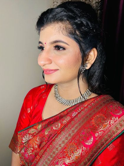 A close-up profile shot, focusing on the clean makeup and simple, elegant jewellery.