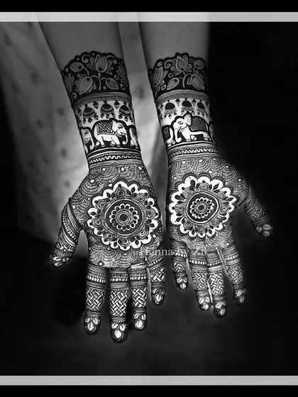A beautiful black and white photo of a mandala design with elephant bands, highlighting the symmetry.