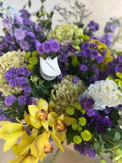 A close-up of my limes and violets arrangement. The combination of yellow cymbidium orchids, purple delphiniums, and lime green hydrangeas is showstopping, screaming opulence and whispering romance.