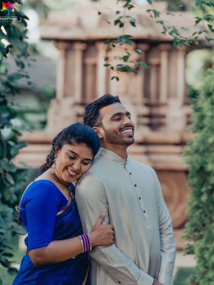 Love and laughter in traditional wear. This candid moment captures the pure joy and comfort the couple shares, proving that traditional shoots can be full of fun.