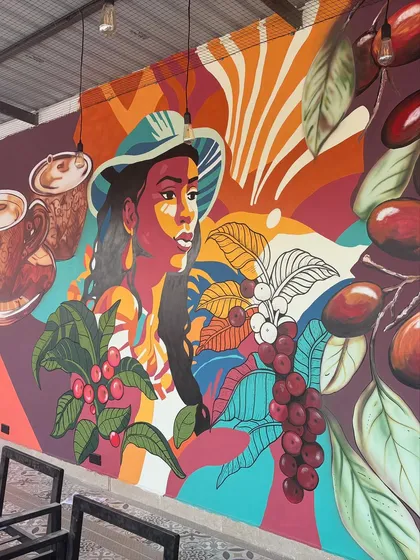 This angle captures the full sweep of the coffee plantation theme, with vibrant foliage and abstract patterns creating a sense of depth and movement.