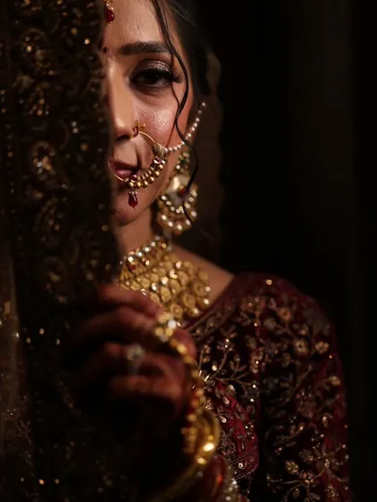 An intimate and mysterious bridal portrait. The makeup focuses on the one visible eye, which is beautifully defined, drawing you into the photo.