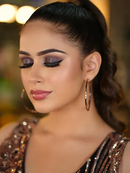 Red carpet glam with a focus on the eyes. This look features a dramatic, glittery winged smokey eye, perfect for making a statement.