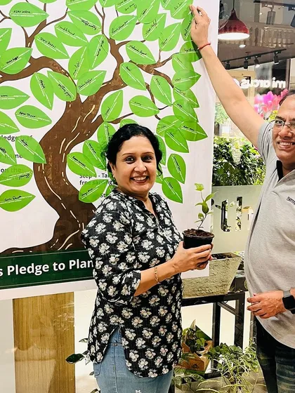 A couple joyfully participates in our pledge drive, taking home a sapling to plant. It's wonderful to see people sharing in the mission to make our planet greener.
