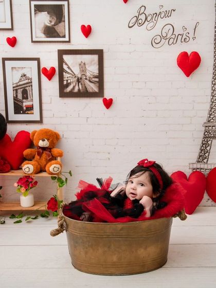 This little baby is relaxing in a tub, looking curious and cute in our Paris-themed Valentine's setup.