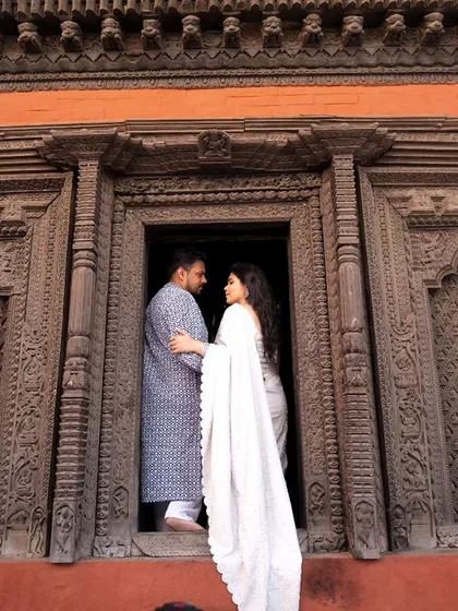 A pre-wedding portrait set against intricately carved wooden doors in Varanasi. The rich textures and history of the location add a layer of depth to their love story.