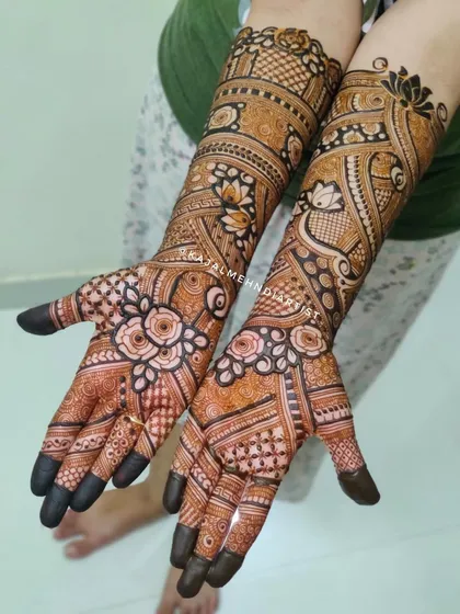 This engagement bridal henna is full of life, with blooming flowers on the palms and intricate patterns covering the arms.