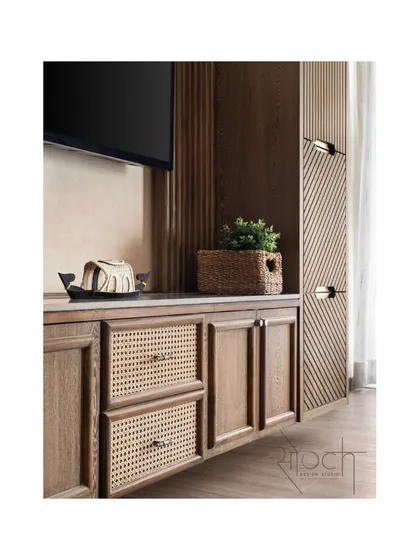A detail of the TV unit in the parent's bedroom, showing the beautiful texture of the wood and cane drawer fronts.