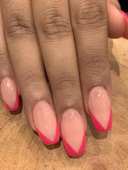 A sharp and modern V-shaped French manicure using a vibrant pink. This is a fun and bold way to update a classic look.