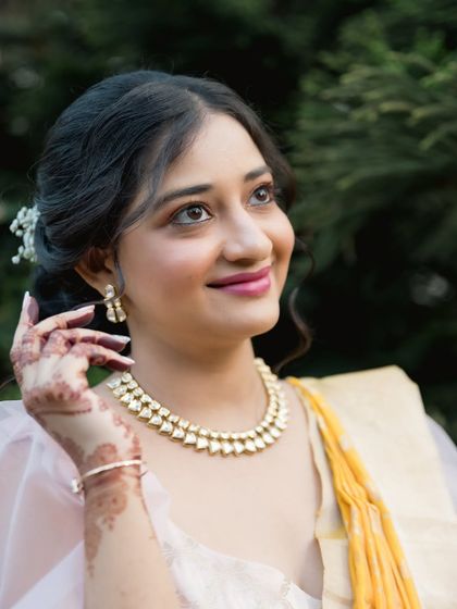 A radiant solo portrait of the bride-to-be, looking up with a hopeful and happy smile. A lovely shot from her modern pre-wedding session.