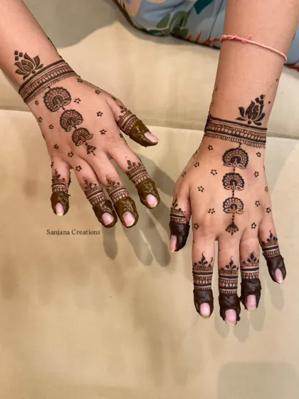 A delicate and modern design for Karwachauth, featuring hanging motifs and lotus bands.