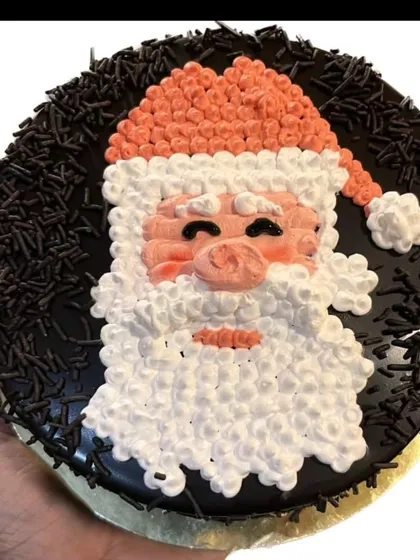 Get into the holiday spirit with our Santa Claus cake. This rich chocolate cake is decorated with a cheerful Santa face made from piped frosting, perfect for a family Christmas celebration.