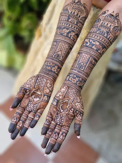 This stunning full-arm bridal mehendi showcases a variety of traditional patterns, including elephants, floral bands, and intricate jaali (net) work.