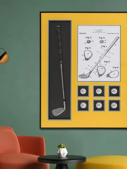 A perfect gift for the golf enthusiast. This pop art shadow box features a miniature golf club, golf balls, and a patent diagram of a club head, all set against a bright yellow background.
